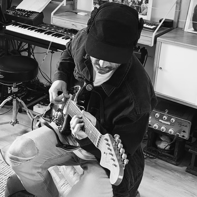 Alberto playing guitar in studio